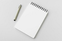 Blank plain white notebook with a pen