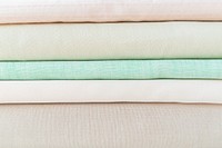 Stack of folded woven fabric patterned background
