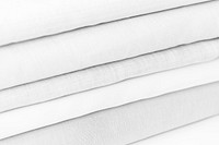 Stack of folded gray and white woven fabric patterned background