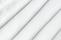 Stack of folded white woven fabric patterned background