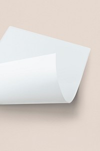 Blank white folded paper mockup on a beige background