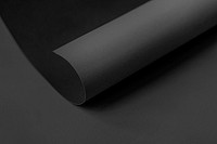 Rolled black chart paper on a dark gray background