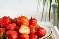 Closeup of strawberries in a white plate. Visit <a href="https://monikagrabkowska.com/" target="_blank">Monika Grabkowska</a> to see more of her food photography.