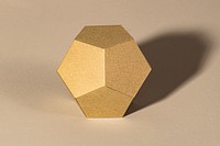 3D golden pentagon shaped paper craft on a beige background