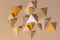 3D pyramid paper craft on a beige background