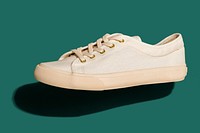 Unisex cream colored sneakers mockup on a teal background