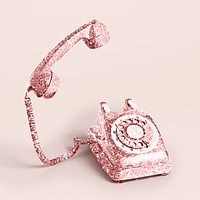 Glittery pink rotary dial on a light pink background 