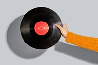 Woman holding a vinyl record mockup on a gray background