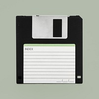 Black floppy disk mockup on a sage green background