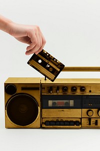Woman inserting a cassette tape into a vintage radio