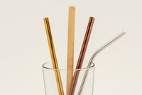 Reusable bamboo and metal straws in a glass 