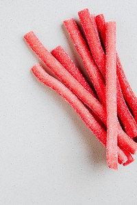 Red chewy candies coated with sugar