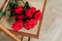 Bunch or red roses on a wooden chair