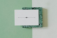 Design icon on white name card on granite cube mockup
