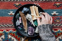 Woman with sage and crystals ready for smudging