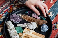 Woman with sage and crystals ready for smudging