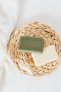 Flat lay organic soap bars with grass flowers in spa setting