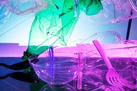 Plastic and other waste polluting the ocean neon background