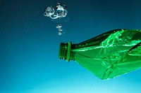 Crumpled plastic bottle polluting the ocean