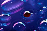 Oil drops floating on water colorful background