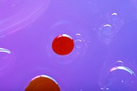 Oil drops floating on water colorful background