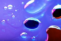 Oil drops floating on water colorful background