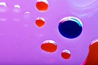 Oil drops floating on water colorful background