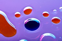 Oil drops floating on water colorful background