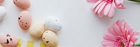 Chocolate Easter eggs and pink gerbera flowers flatlay