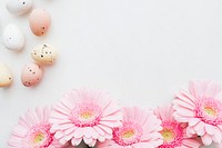 Chocolate Easter eggs and pink gerbera flowers flatlay