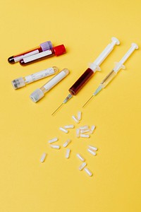 Blood test and vaccines on yellow background