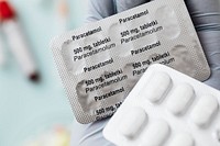 Hand holding paracetamol medicine packets
