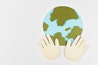 Hands supporting the planet earth during coronavirus pandemic paper craft background