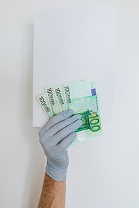 Gloved hands holding a blank paper with Euro currency