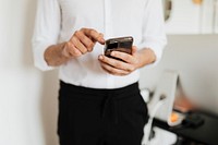 Businessman checking his social media account and messages on a phone