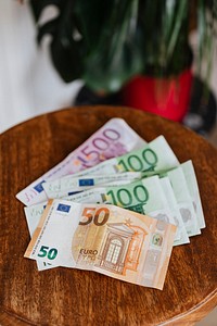Euro banknotes on a wooden table
