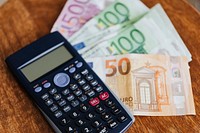 Calculator and Euro banknotes on a table