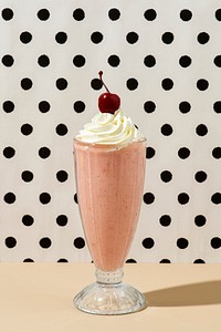Strawberry milkshake with a maraschino cherry on top