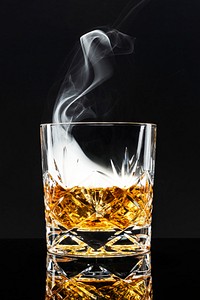 Smoked whisky cocktail on black background