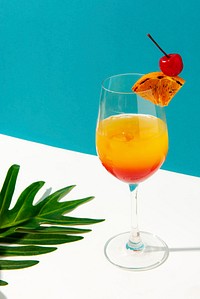 Tequila sunrise cocktail on blue background