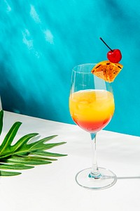 Tequila sunrise cocktail on blue background