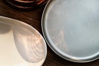 Ceramic trays with a sunlight on a wooden table