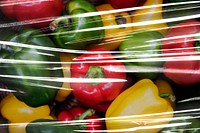 Fresh bell peppers covered with plastic wrap textured background wallpaper