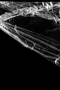 Wrinkled plastic wrap texture on a black background