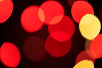 Red and yellow bokeh pattern design element on a dark background