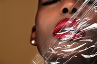 Beautiful black woman behind a plastic wrap wallpaper background