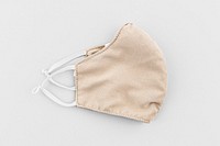 Beige fabric face mask on a gray  background