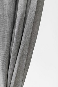 Gray drapery hanging from a curtain rod