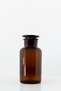 Empty medical brown glass bottle with a glass lid