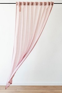 Pink drapery curtain hanging from a curtain rod